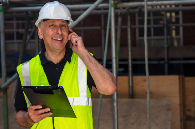 Builder on the phone to a client